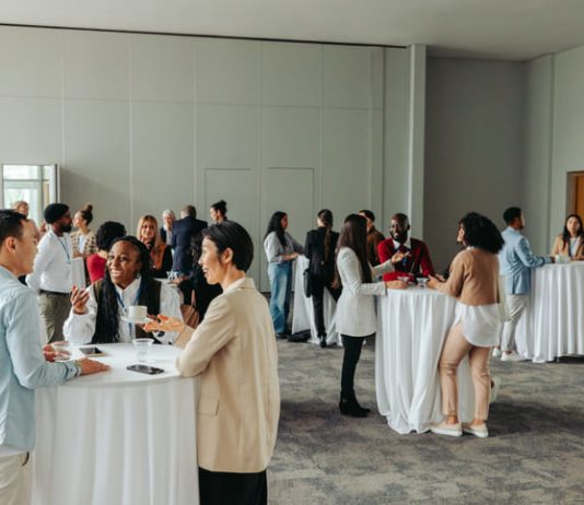 Diverse professionals networking and socializing at a business event
