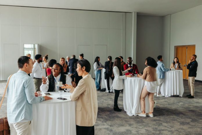 Diverse professionals networking and socializing at a business event