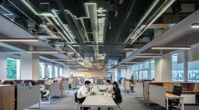 man and woman sitting on table in the office