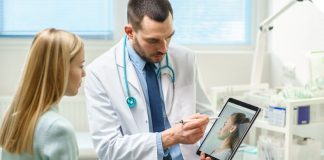 How to Find the Best Mommy Makeover Surgeon Near You Plastic / Cosmetic Surgeon Consults Woman about Facial Lift Surgery, He Draws Arrows on Digital Tablet Computer Screen, Showing Types of Facelift, Forehead Correcting Procedures Available for Her.