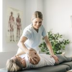 Modern rehabilitation chiropractor worker with woman client for chronic pain