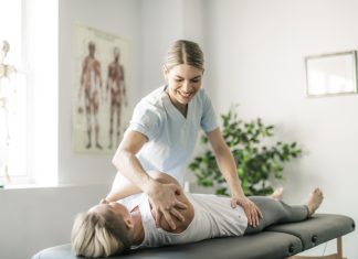 Modern rehabilitation chiropractor worker with woman client for chronic pain