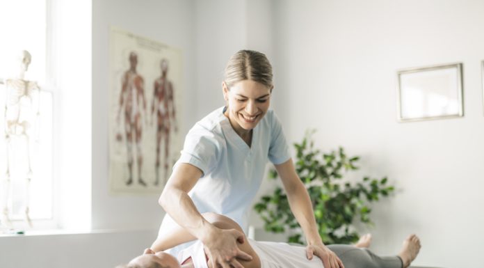 Modern rehabilitation chiropractor worker with woman client for chronic pain