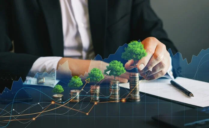 Eco business and nature investment. Green business growth. Businessman holding coin with tree growing on money coin stack. Finance sustainable development.