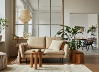 Home furnishing living room interior composition with beige sofa, wooden coffee table and modern home accessories.