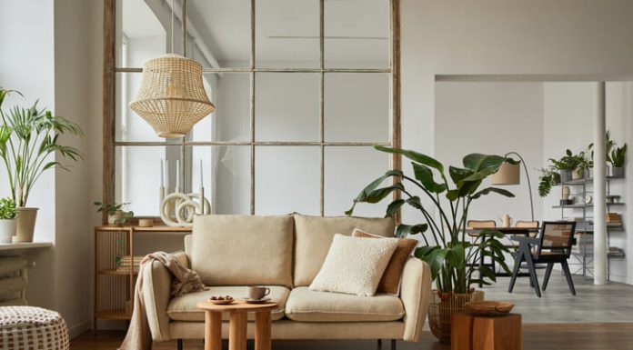 Home furnishing living room interior composition with beige sofa, wooden coffee table and modern home accessories.