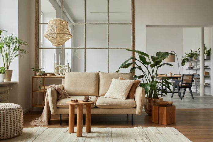 Home furnishing living room interior composition with beige sofa, wooden coffee table and modern home accessories.