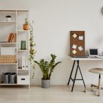 How to Repurpose Household Items into Functional Office Tools Minimal background image of cozy home office workplace in white tones decorated with green plants, copy space