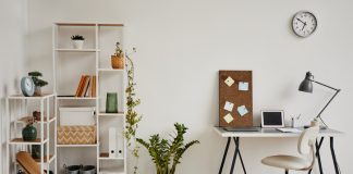 How to Repurpose Household Items into Functional Office Tools Minimal background image of cozy home office workplace in white tones decorated with green plants, copy space