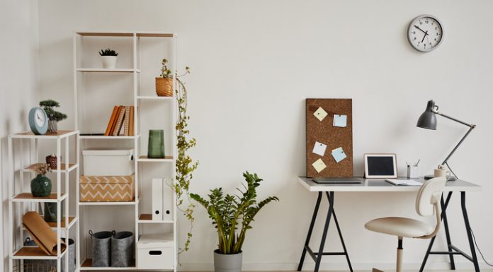 Minimal background image of cozy home office workplace in white tones decorated with green plants, copy space