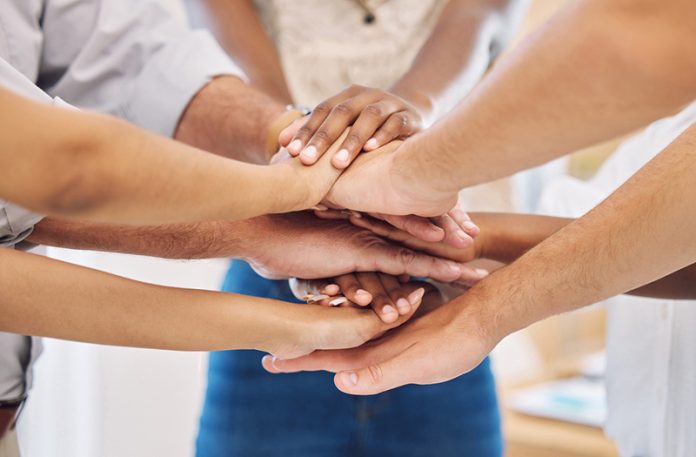 Team building , teamwork and motivation with hands of business people goals, community and collaboration mindset. Diversity, trust and support in employees in innovation, success and vision meeting Cultivating Endurance: Sharing a Case for Empowering an Organization’s Resilience and Enhancing Wellbeing