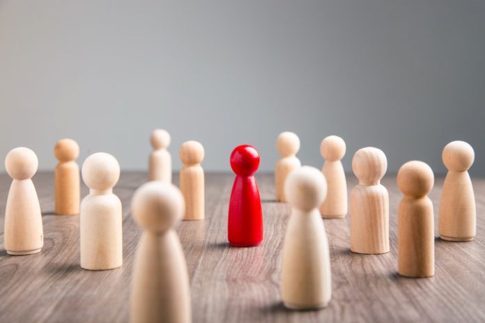 The wooden figures stood out from the crowd. Wooden figure for personal brand