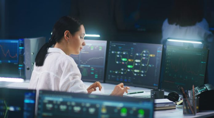 MIB in Networking technical specialist works on computer with data server