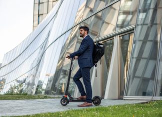 Smart mobility in the workplace. Businessman riding an electric vehicle going home after work