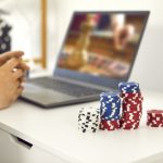 male gambler playing online roulette game and matadorbet.