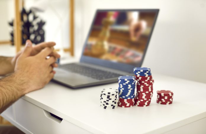 male gambler playing online roulette game and matadorbet.
