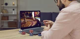 A Beginner’s Guide to Navigating the Online Gaming Economy Gambler man sitting at laptop playing online casino roulette on gaming economy