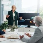 Presentation, paperwork and board directors in office with team for AI governance system.