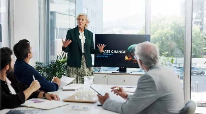 Presentation, paperwork and board directors in office with team for AI governance system.