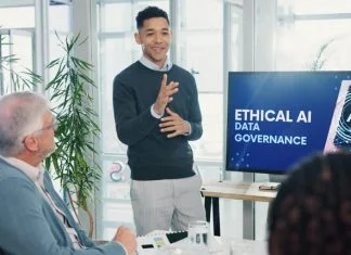 Man, presentation and screen with meeting for AI ethics, smile and planning for future web development at office. Person, speaker and staff in boardroom with data governance at startup tech agency