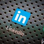 LinkedIn Scraping 101: How It Works and Why It Matters Social media icons and LinkedIn on smart phone screen.