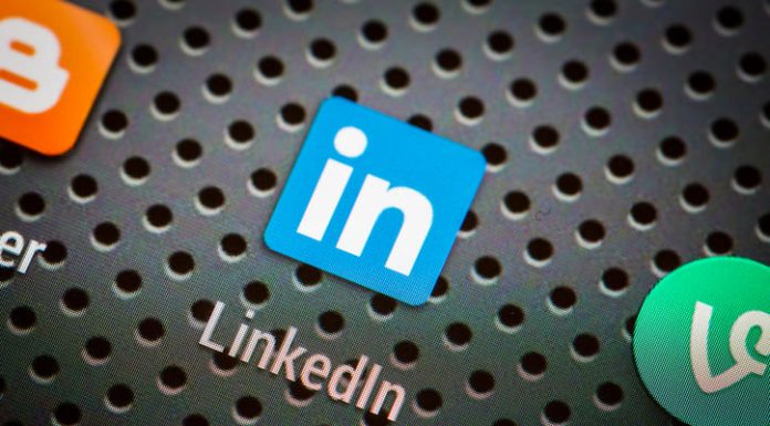 Social media icons and LinkedIn on smart phone screen.