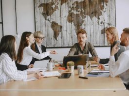 Young entrepreneurs in a modern office discussing Hong Kong company registration & digital strategies for modern startups.