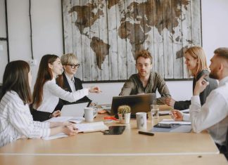 Young entrepreneurs in a modern office discussing Hong Kong company registration & digital strategies for modern startups.