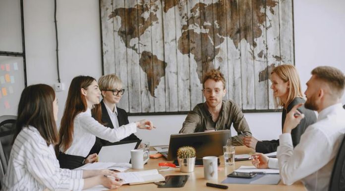 Young entrepreneurs in a modern office discussing Hong Kong company registration & digital strategies for modern startups.