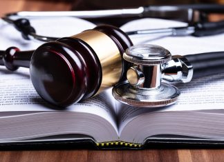 Lawyers to Sue Doctors Over Misdiagnosis and Critical Treatment Errors Doctors - Stethoscope And Mallet Over Opened Law Book