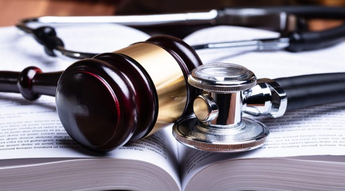Lawyers to Sue Doctors Over Misdiagnosis and Critical Treatment Errors Doctors - Stethoscope And Mallet Over Opened Law Book