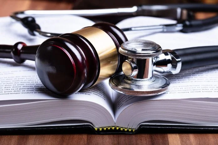 Doctors - Stethoscope And Mallet Over Opened Law Book