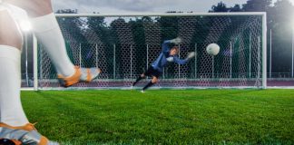 Football and the Economy: The Impact of Transfers and Club Investments Club - Anonymous Soccer Player Kicks Ball on Penalty