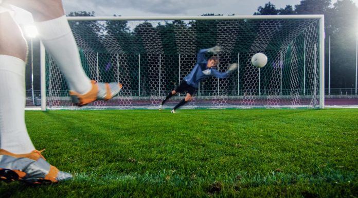 Football and the Economy: The Impact of Transfers and Club Investments Club - Anonymous Soccer Player Kicks Ball on Penalty