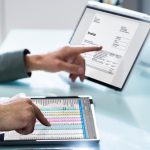 Electronic Invoice Spreadsheet Software, OCR and Corporate Invoice On Computer