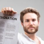 Leaving Your Job the Right Way: Writing a Resignation Letter with Professionalism holding up a resignation letter