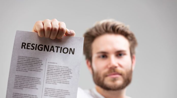 Leaving Your Job the Right Way: Writing a Resignation Letter with Professionalism holding up a resignation letter