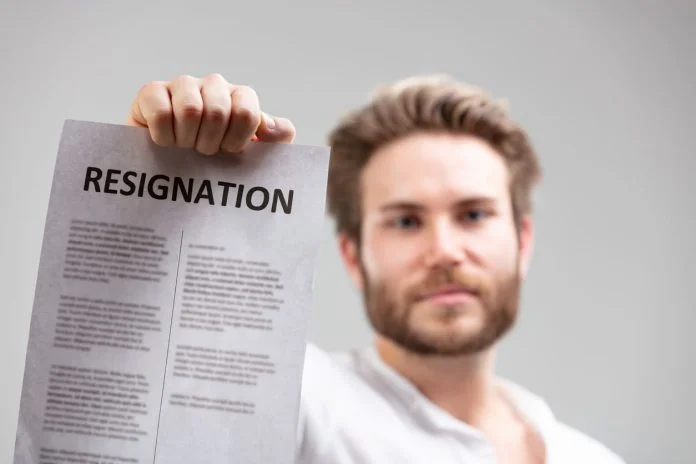 iStock-1317477180 (1) holding up a resignation letter