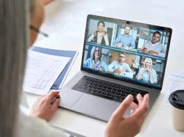 Remote Team Building Activities That Actually Work Remote teams having a videocall on financial report using laptop
