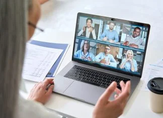 Remote Team Building Activities That Actually Work Remote teams having a videocall on financial report using laptop