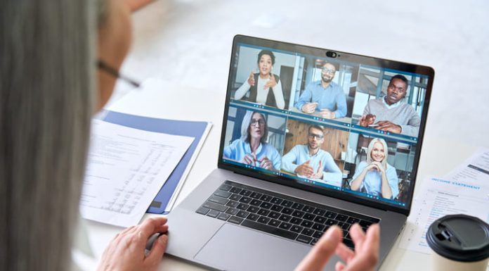 Remote Team Building Activities That Actually Work Remote teams having a videocall on financial report using laptop