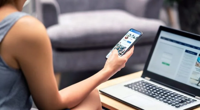 Why Your Facebook Posts Aren’t Getting the Likes Facebook profile page in smartphone screen at work.