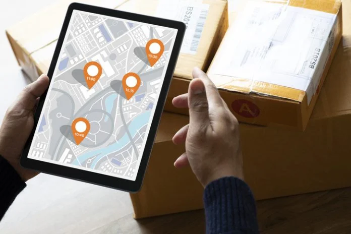 Delivery and online shopping concepts with young person using digital map with tablete on product package box Delivery online tracking shipment