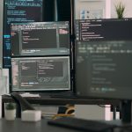 CodeRabbit - Desk with multiple screens
