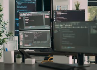 CodeRabbit - Desk with multiple screens