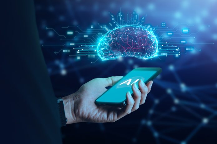 Businessman holding mobile phone with AI icon artificial intelligence on screen and brain above.big data, science, innovation technology, cloud computing, futuristic, internet network communication concept AI leapfrog