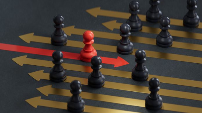 Red pawn facing different position for leadership transformation