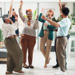 Why Great Teams Need Both the Positive Emotions of Sustaining and Striving Employees in the office showing positive emotions