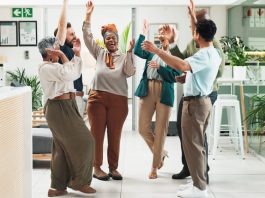Why Great Teams Need Both the Positive Emotions of Sustaining and Striving Employees in the office showing positive emotions