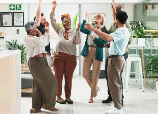 Why Great Teams Need Both the Positive Emotions of Sustaining and Striving Employees in the office showing positive emotions